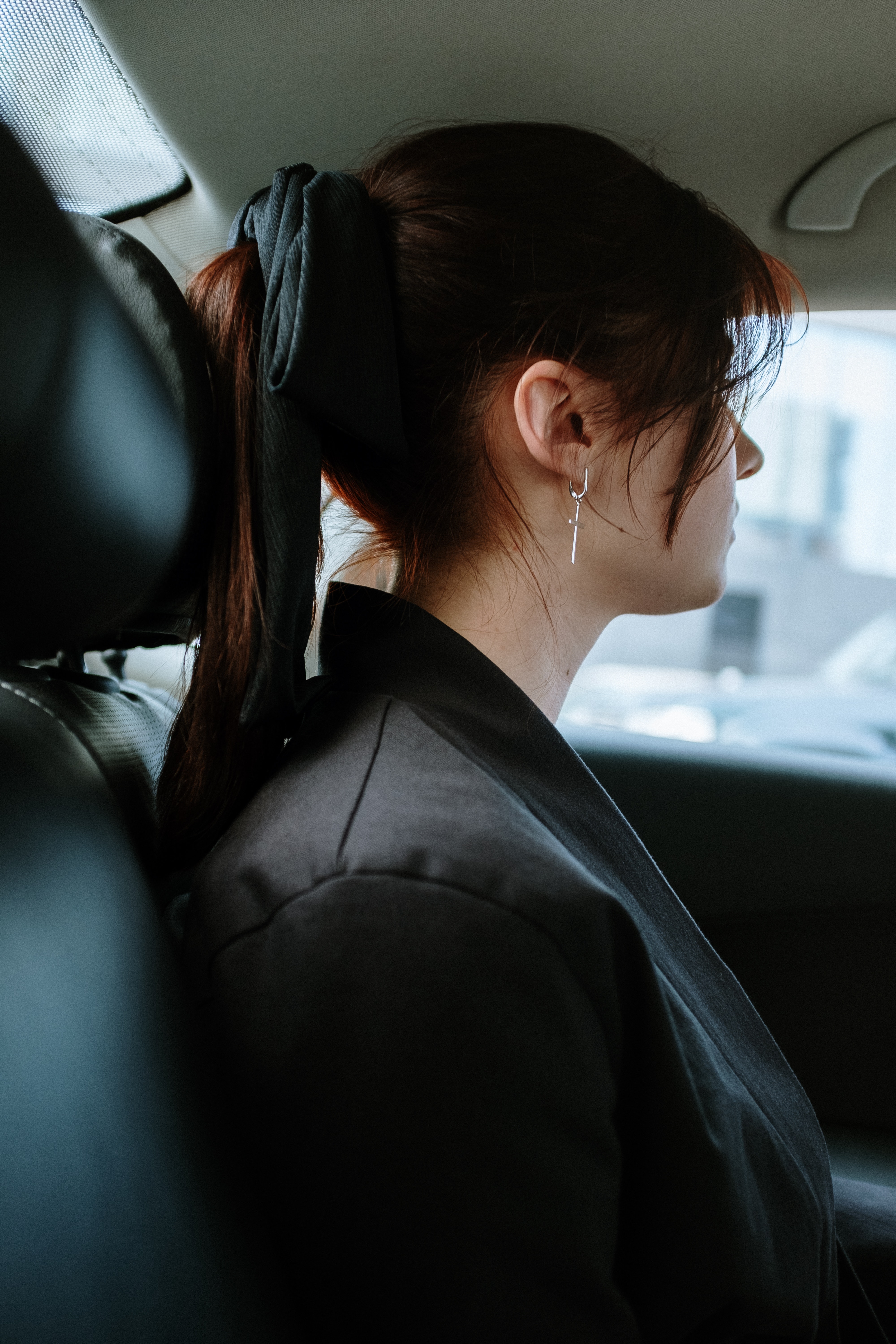 girl riding in back seat of car